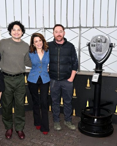 Giorgia Wingham in chic black mini dress and bold knee-high boots