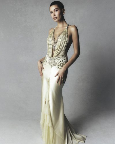 Hailey Bieber in a soft cream gown featuring dramatic silhouette