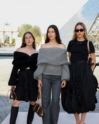 Este Haim in black twisted sweater and ruffled black skirt.