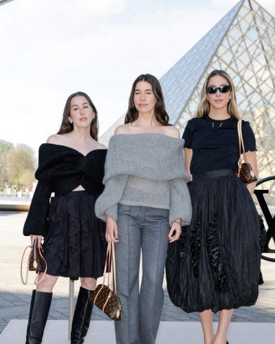 Danielle Haim black top enhances her graceful flowy skirt.