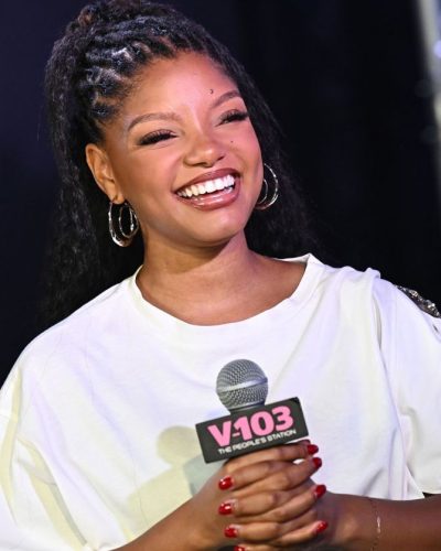 Halle Bailey wearing a white T-shirt and fashionable denim.