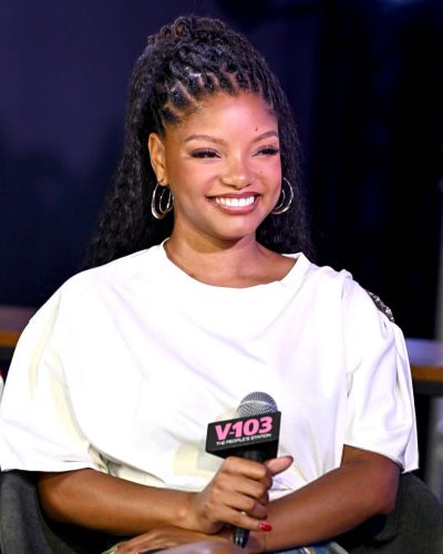 Halle Bailey in a crisp white tee and high-waisted jeans.