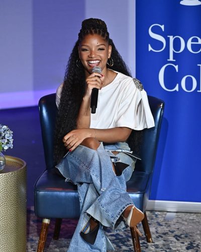 Halle Bailey trendy ripped jeans in modern streetwear style