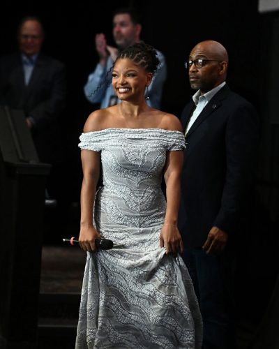 Halle Bailey in a stylish white dress with graceful flow.