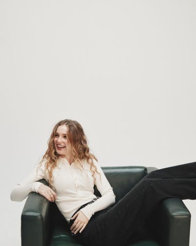 Hannah Dodd in stylish neutral blazer and elegant blouse.