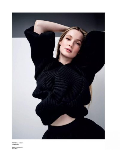 Hannah Dodd in a sleek black dress featuring delicate pleats.