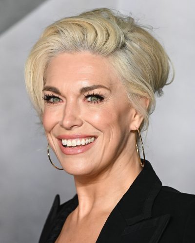 Hannah Waddingham wearing structured black blazer over gown.