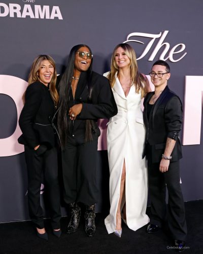 Heidi Klum wearing white gown featuring a dramatic leg slit