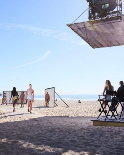 Heidi Klum wearing a white crochet dress with feather trim.
