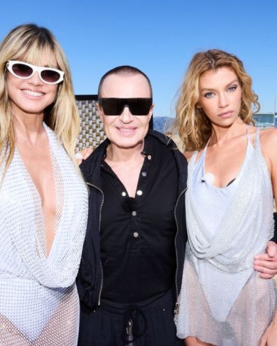 Heidi Klum in a white dress with intricate crochet details.