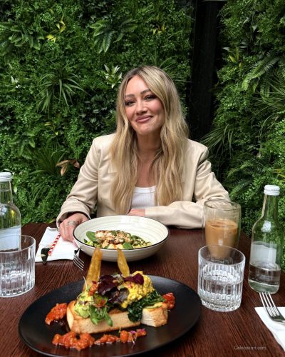 Hilary Duff wearing cream leather jacket with casual blue jeans.