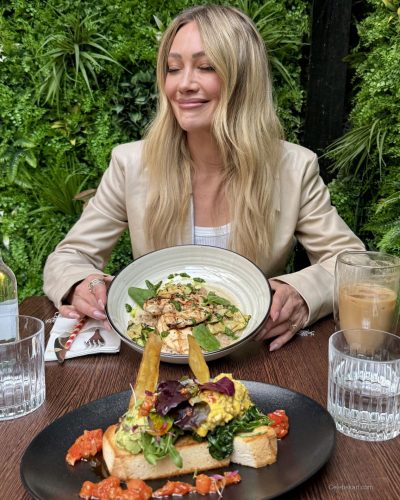 Hilary Duff styled with cream leather jacket and blue jeans.