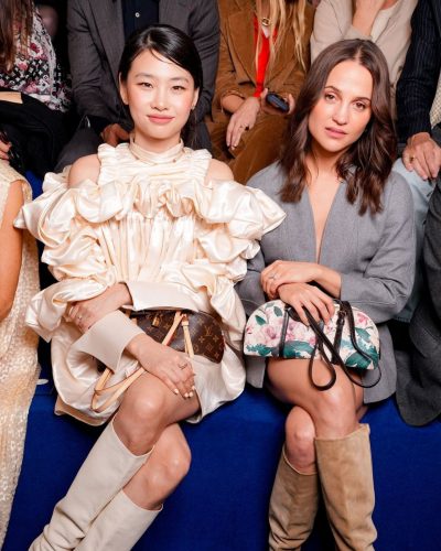 Hoyeon Jung in a cream-colored dress with oversized sleeves.