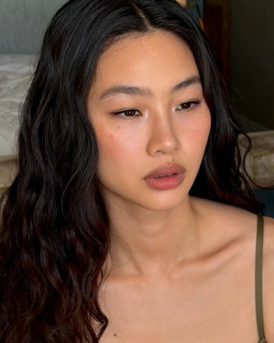 Hoyeon Jung features a blue jersey and chic black skirt.