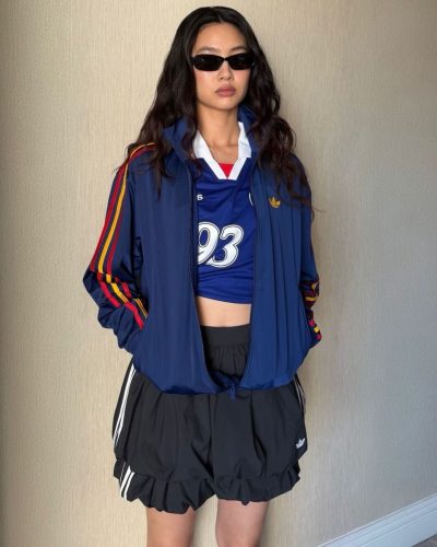 Hoyeon Jung dons a blue jersey with white striped black skirt.