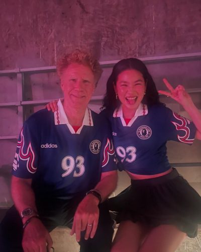 Hoyeon Jung in a sporty blue jersey and flowing black skirt.