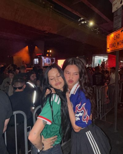 Hoyeon Jung styled in a bold blue jersey and black skirt.