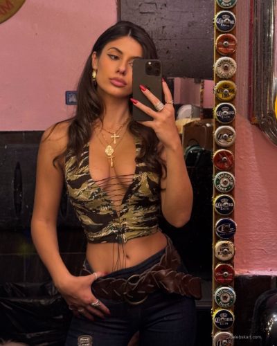 Ines Trocchia draped in a luxurious black coat.