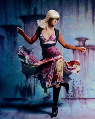 Iris Law in a floral skirt complemented by pink accessories.