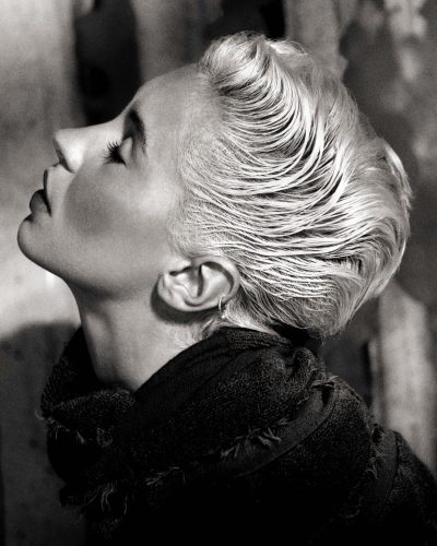 Iris Law wears a light pink jacket over floral skirt.