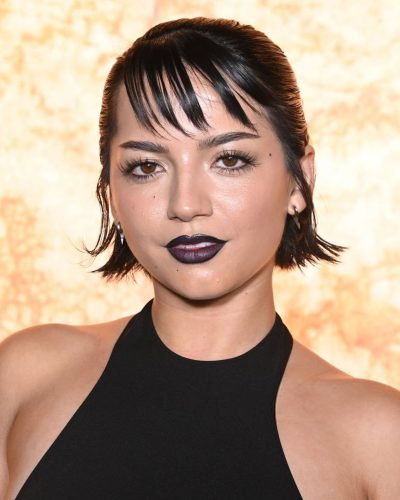 Isabela Merced black dress with high neckline and elegant slit