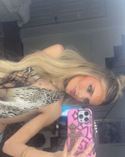 Izzy Darnell sporting a soft pink dress with a relaxed fit.