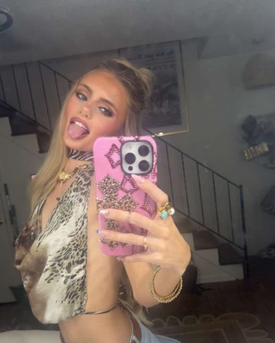 Izzy Darnell wearing a lightweight pink dress with flowing fabric.