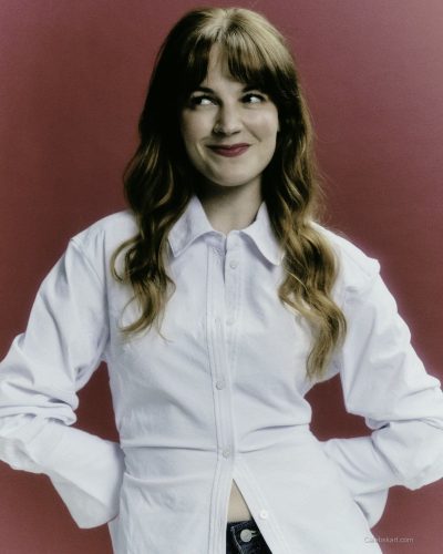 Izzy Meijle-Small wearing a chic black gown with shimmering details.