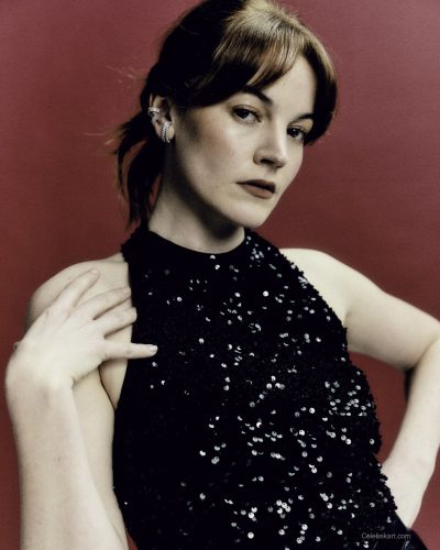 Izzy Meijle-Small in a stylish black dress with statement earrings.