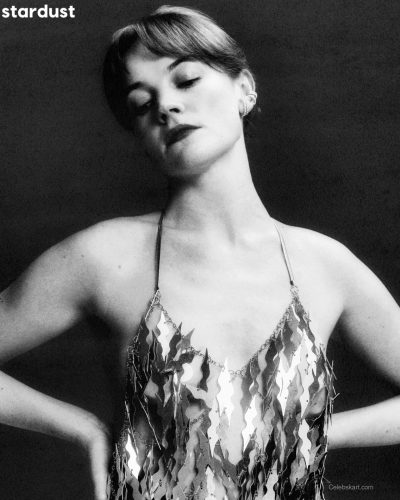 Izzy Meikle-Small wears a silver dress with sleek lines and texture.