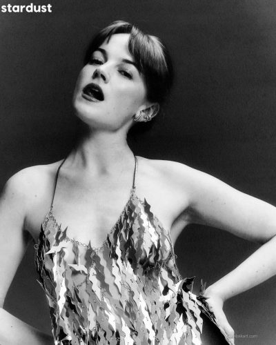 Izzy Meikle-Small wears a silver gown accentuating her silhouette.