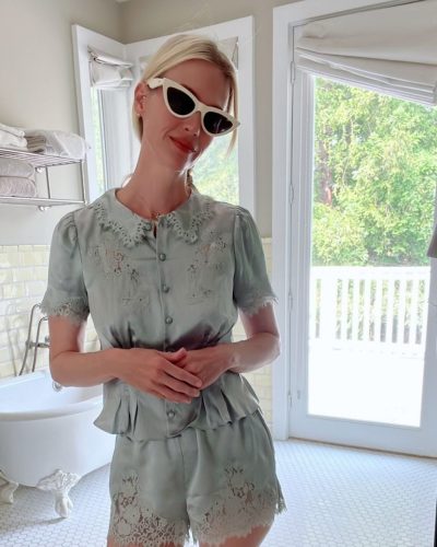 January Jones styled in cream cardigan over delicate lace shorts