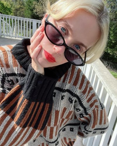 January Jones wearing cozy cream cardigan with playful lace accents