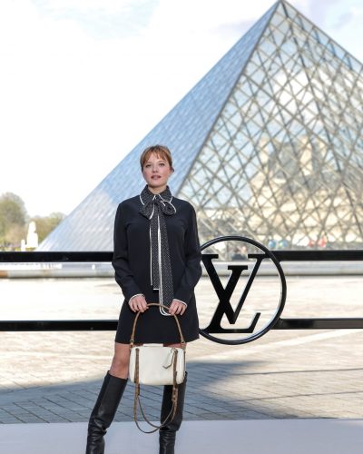 Jella Haase black fitted dress with polka-dot collar and knee-high boots