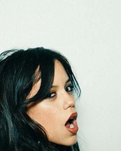 Jenna Ortega in a tailored fit muted color gown.