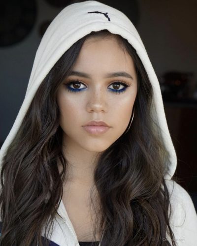 Jenna Ortega with playful rings and accessories on hand.