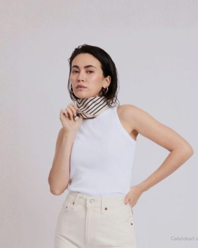Jessica Henwick cream trousers paired with striped silk scarf