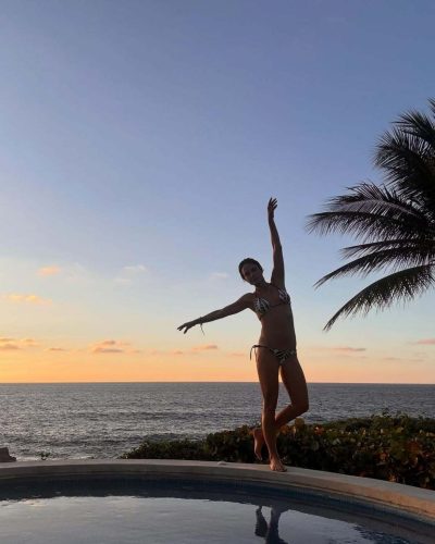 Jordana Brewster wearing a chic black and white swimsuit