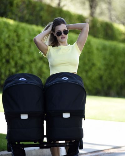 Joy Corrigan wearing a snug yellow crop top and mini skirt.