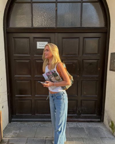 Jules Marie Jensen relaxed seated pose on wooden steps