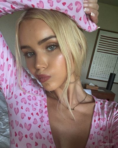 Julia Cavanagh in a long-sleeve pink bodysuit, casual style.