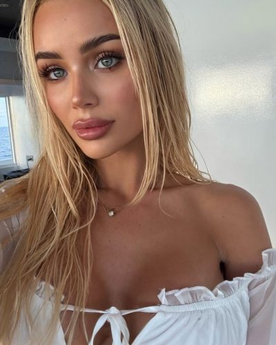 Julia Cavanagh in light skirt creating movement by the beach