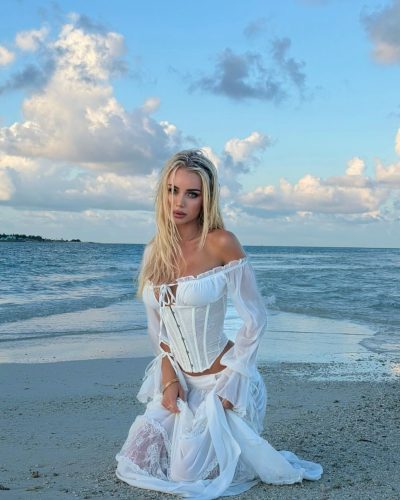 Julia Cavanagh in white corset with intricate lace details