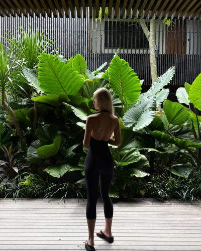 Julia Cavanagh in a sleek black top and high-waisted leggings.