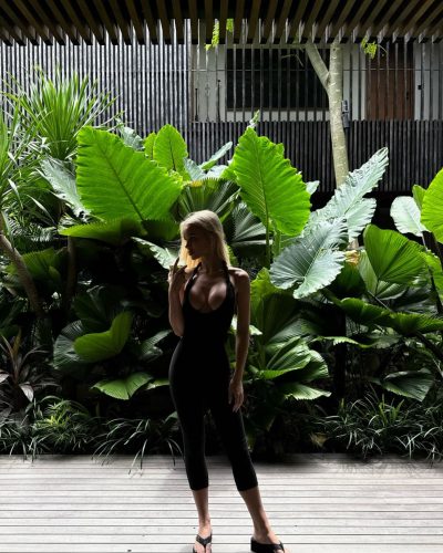 Julia Cavanagh wearing a black form-fitting top with flowing hair.