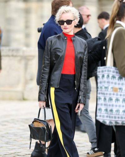 Julia Garner black trousers with yellow stripes detail