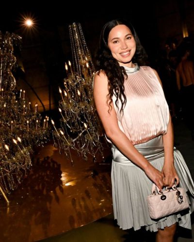 Jurnee Smollett against backdrop of beautiful chandeliers.