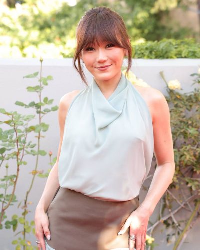 Karen Fukuhara halter neck top and neutral flowing skirt