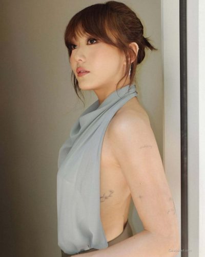 Karen Fukuhara styled with minimalist accessories and flowing dress.