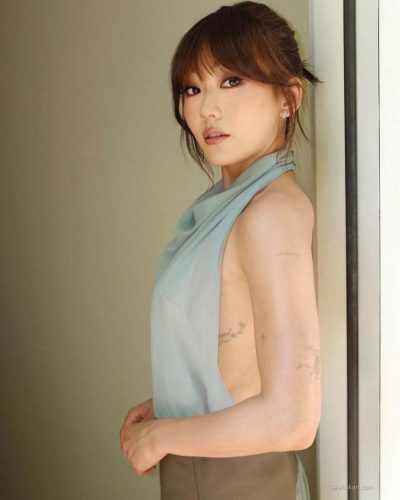Karen Fukuhara in a light blue gown with high neckline.